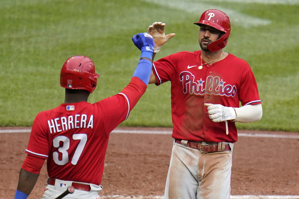 Philadelphia Phillies' Nick Castellanos, right, is greeted by Odubel Herrera after scoring on a single by Matt Vierling off Pittsburgh Pirates relief pitcher Dillon Peters during the fifth inning of a baseball game in Pittsburgh, Sunday, July 31, 2022. (AP Photo/Gene J. Puskar)