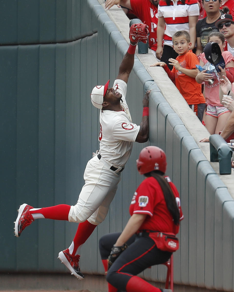 Cincinnati Reds' Yasiel Puig catches a foul ball hit by Los Angeles Dodgers' Hyun-Jin Ryu in the sixth inning of a baseball game, Sunday, May 19, 2019, in Cincinnati. (AP Photo/John Minchillo)