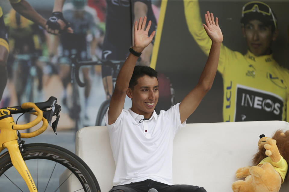 Tour de France winner Egan Bernal waves to the crowd as he is welcomed home to Zipaquira, Colombia, Wednesday, Aug. 7, 2019. Bernal rode into the town's central square on his bike on wearing the Tour de France's iconic yellow jersey. A group of some 3,000 supporters dressed in the same color chanted his name. (AP Photo/Ivan Valencia)
