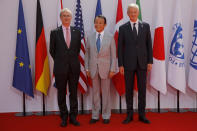 French Finance Minister Bruno Le Maire, right, welcomes Japan's Finance Minister Taro Aso , center, with Governor of the Bank of France Francois Villeroy de Galhau, at the G-7 Finance Wednesday July 17, 2019.The top finance officials of the Group of Seven rich democracies are arriving at Chantilly, at the start of a two-day meeting aimed at finding common ground on how to tax technology companies and on the risk from new digital currencies. (AP Photo/Michel Euler)