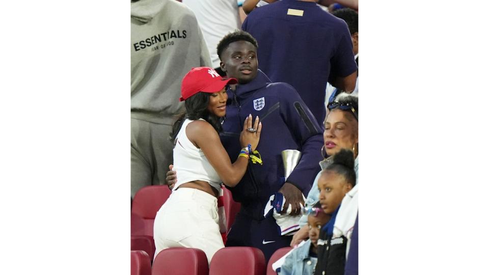 girlfriend hugging boyfriend in stands 