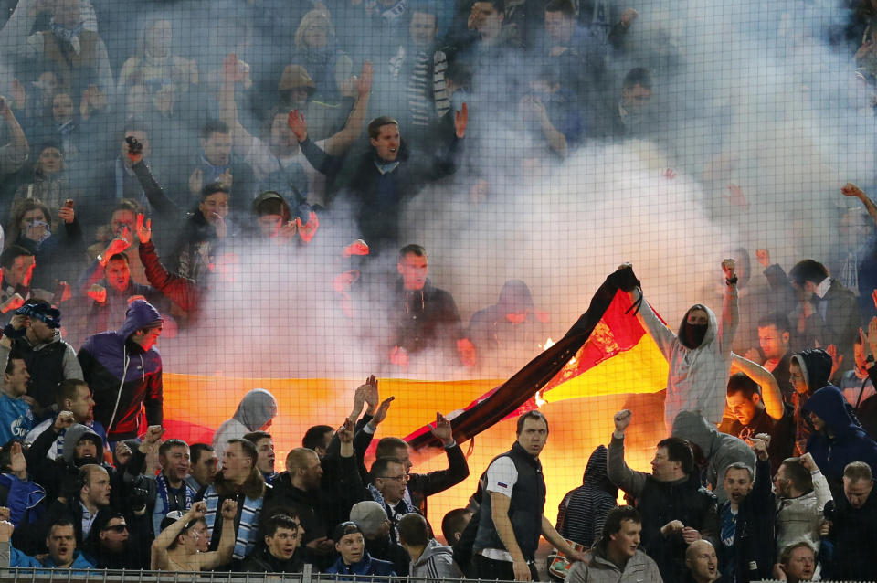 Zenit supporters burn a German flag during the Champions League round of 16 second leg soccer match between Borussia Dortmund and FC Zenit in Dortmund, Germany, Wednesday, March19,2014. (AP Photo/Frank Augstein)