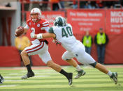 LINCOLN, NE - OCTOBER 29: Quarterback Taylor Martinez #3 of the Nebraska Cornhuskers tries to slip past linebacker Max Bullough #40 of the Michigan State Spartans during their game at Memorial Stadium October 29, 2011 in Lincoln, Nebraska. (Photo by Eric Francis/Getty Images)