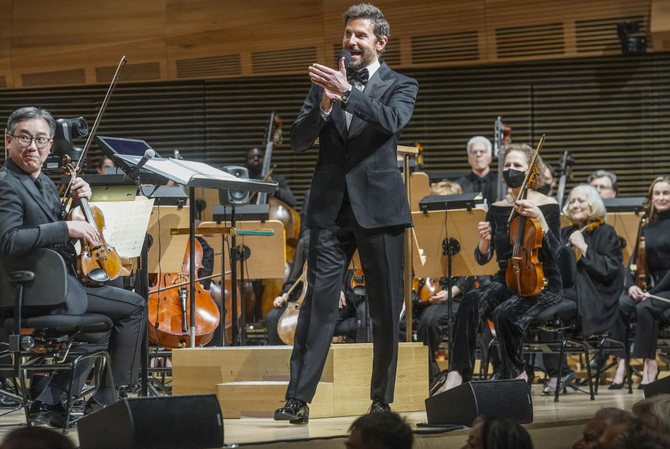 Actor and director Bradley Cooper, center, address audience before the New York Philharmonic performance of Leonard Bernstein's music from his movie "Maestro," conducted by the Metropolitan Opera and philharmonic's new music director Yannick Nézet-Séguin, Wednesday, Feb. 14, 2024, in New York. (AP Photo/Bebeto Matthews)