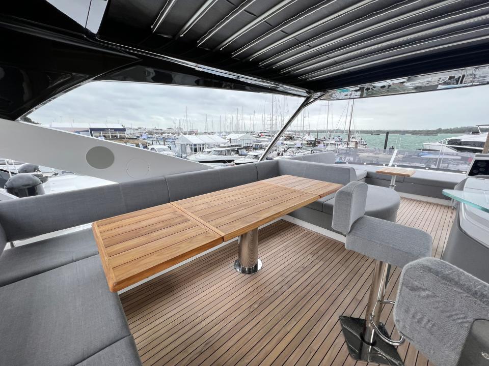 A grey u-shaped couch on the Sunseeker 76