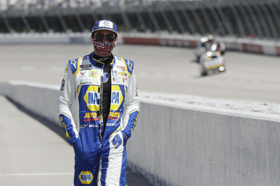 Driver Chase Elliott walks to his car for the start of the NASCAR Cup Series auto race Sunday, May 17, 2020, in Darlington, S.C. (AP Photo/Brynn Anderson)