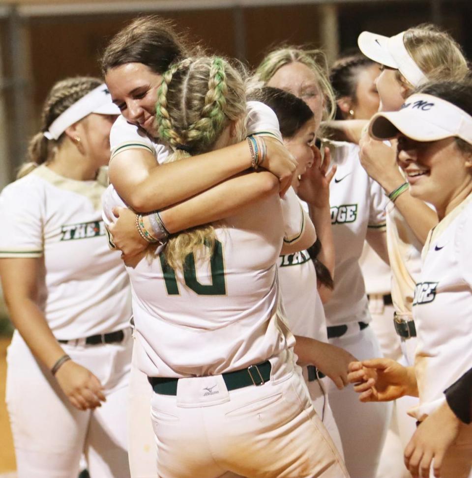 Jenna Gardner (10) hugs her teammate in celebration of Catawba Ridge’s 10-7 win over South Florence to clinch its first ever softball state title. Justin Driggers