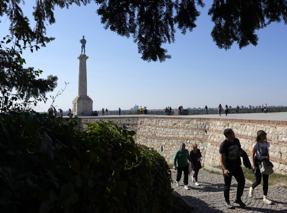 Tourists walk on Kalemegdan fortress in Belgrade, Serbia, Sunday, Oct. 3, 2021. Russians are flocking to Serbia to receive Western-approved COVID-19 shots. Although Russia has its own vaccine known as Sputnik V, the shot has not been approved by international health authorities. (AP Photo/Darko Vojinovic)