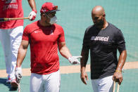 Los Angeles Angels center fielder Mike Trout, left, talks with first baseman Albert Pujols during baseball practice at Angel Stadium on Wednesday, July 8, 2020, in Anaheim, Calif. (AP Photo/Ashley Landis)