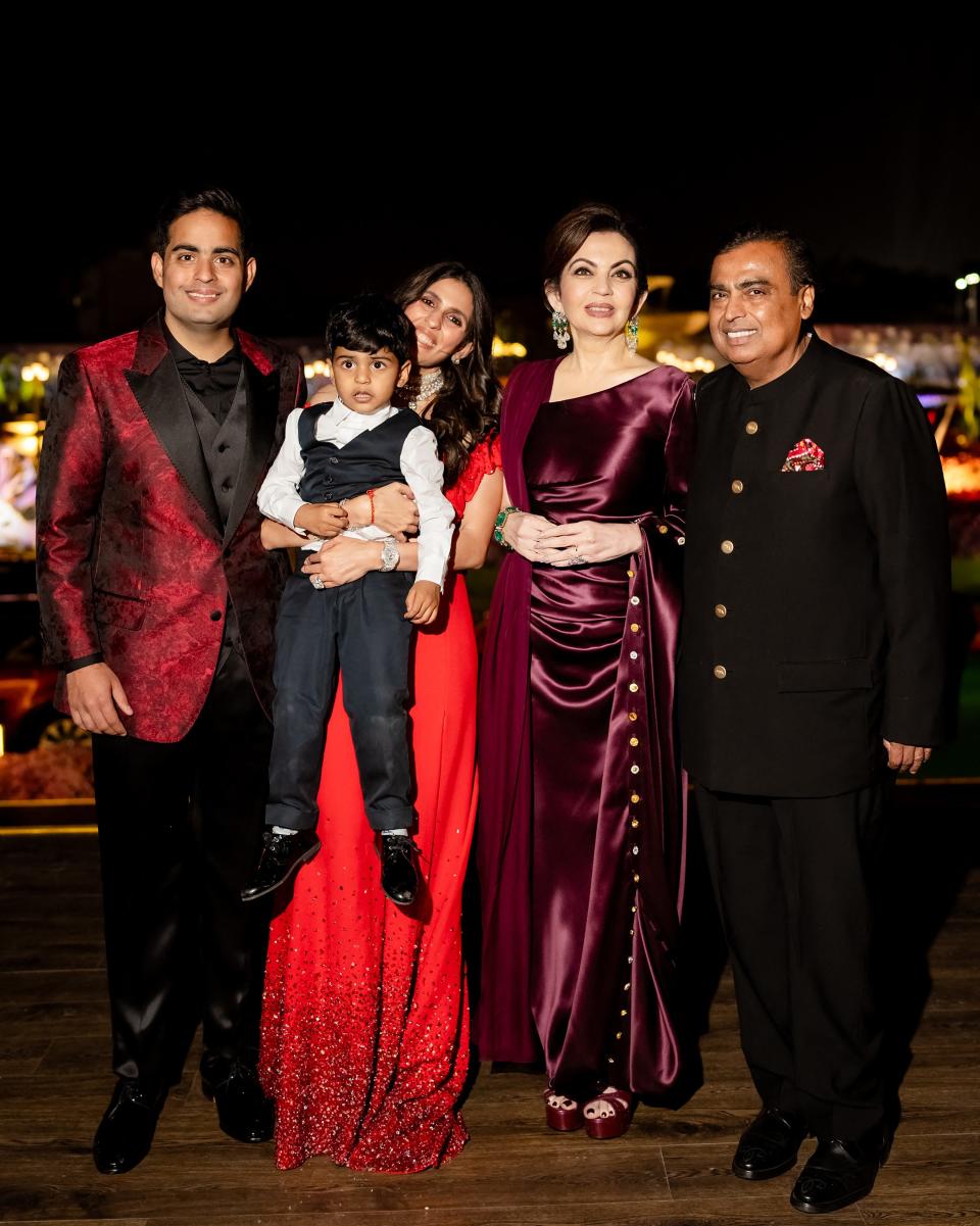 This handout photograph taken and released by Reliance on March 1, 2024, shows billionaire tycoon Mukesh Ambani (R), with wife Nita Ambani (2R), son Akash Ambani (L) and daughter-in-law Shloka Mehta during a three-day pre-wedding celebration for his son Anant Ambani and Radhika Merchant in Jamnagar.