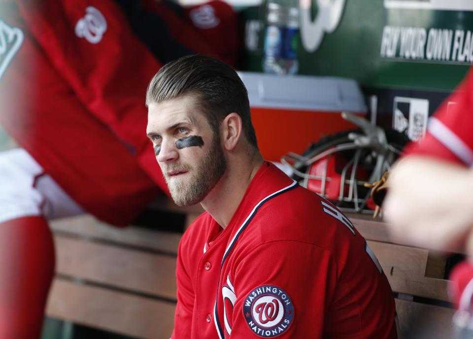 dWashington Nationals' Bryce Harper sits on the bench during the fourth inning of a baseball game against the St. Louis Cardinals at Nationals Park on Saturday, April 19, 2014, in Washington. The Cardinals won 4-3. Harper was pulled early from a game after Washington manager Matt Williams said the young outfielder didn't hustle. Harper was taken out after six innings. The 21-year-old Harper is a two-time All-Star known for his aggressive play. But in the sixth inning, he hit the ball to the mound, jogged to first and took a right turn to the dugout before getting halfway down the basepath. (AP Photo/Alex Brandon)