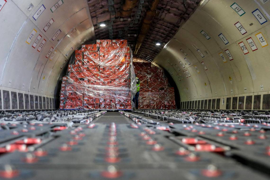 Avianca Cargo employees unload boxes with flowers from a cargo plane arriving at Miami International Airport on Monday, Feb. 6, 2023.