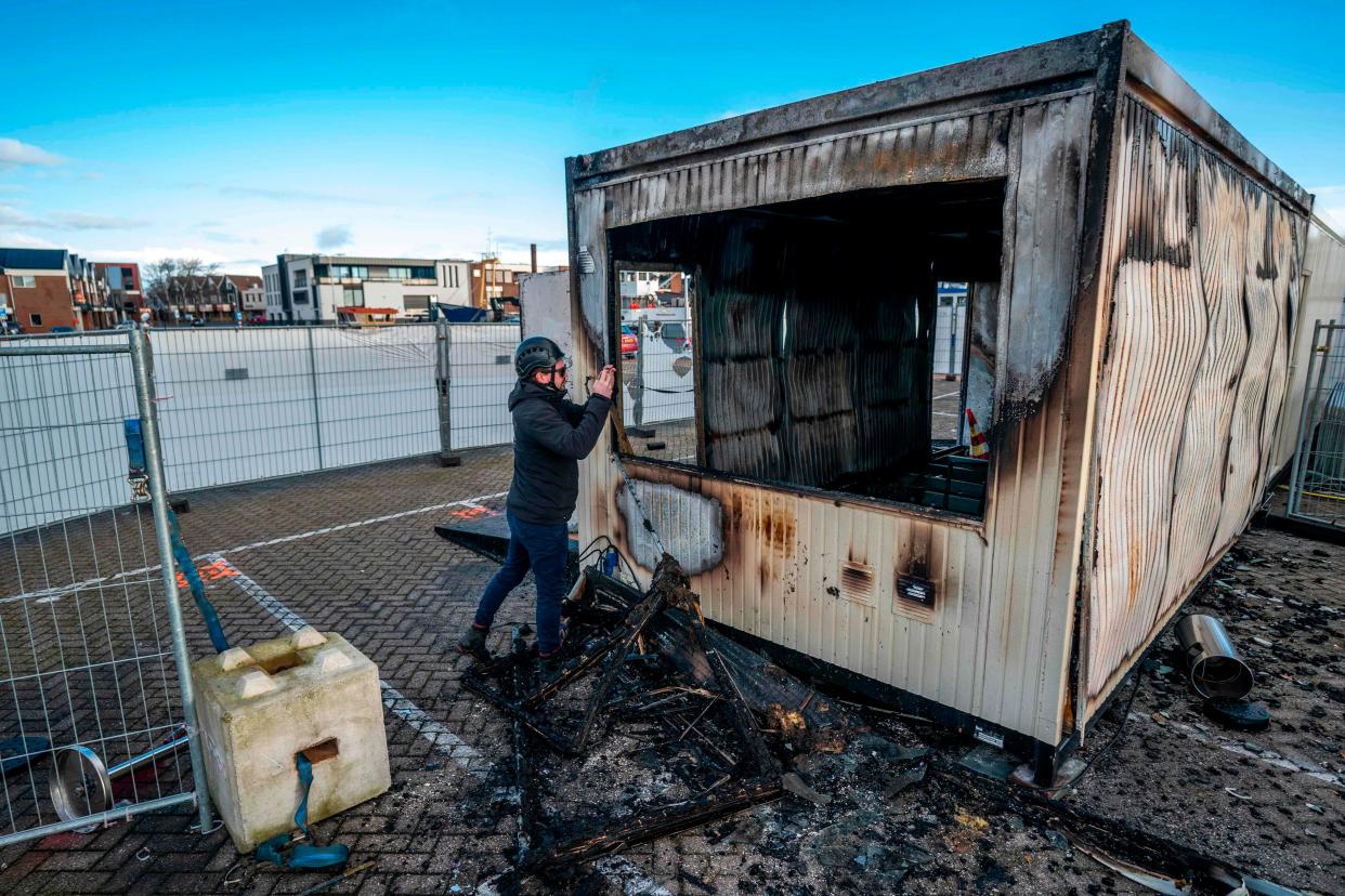 A torched-out coronavirus test centre is photographed in the port town of Urk on 24 January, 2021, the day after anti-curfew rioters set it on fire. (ANP/AFP via Getty Images)