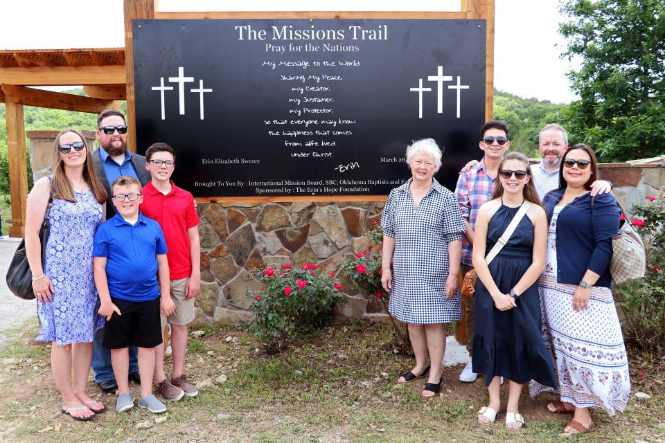 Erin Swezey's family members pose for a photo at the entrance of the new Missions Trail at Falls Creek Baptist Camp & Conference Center near Davis.