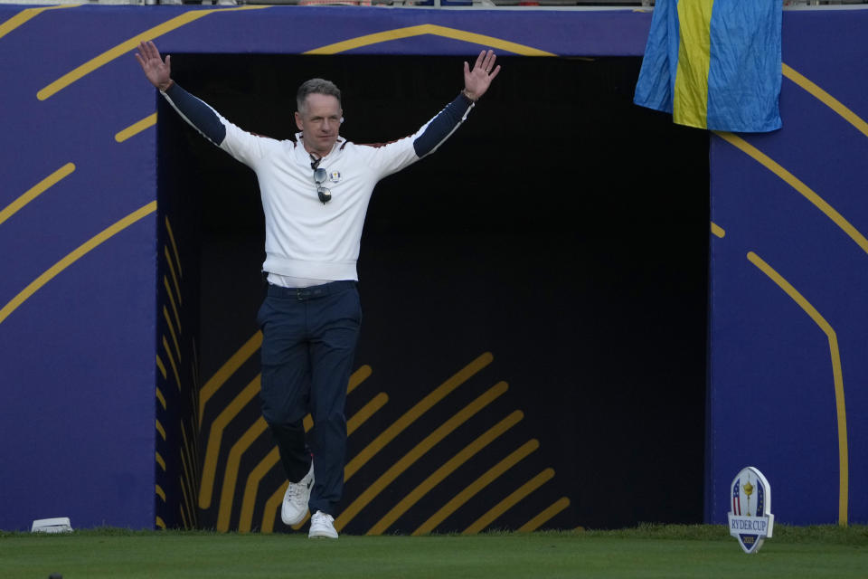 Europe's Team Captain Luke Donald greets the fans on the 1st tee ahead of the morning Foursomes matches at the Ryder Cup golf tournament at the Marco Simone Golf Club in Guidonia Montecelio, Italy, Saturday, Sept. 30, 2023. (AP Photo/Andrew Medichini)