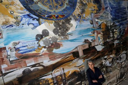 Artist Jackie Kazarian poses for a portrait in front of her painting for "Project 1915", a commemorative piece marking the 100th anniversary of the Armenian genocide, in Chicago, Illinois, March 23, 2015. REUTERS/Jim Young