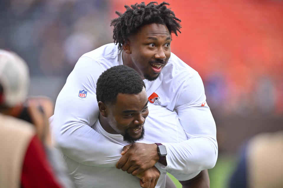 Cleveland Browns defensive end Myles Garrett, top, hops on the back of defensive tackle Jordan Elliott after an NFL preseason football game against the Philadelphia Eagles in Cleveland, Sunday, Aug. 21, 2022. (AP Photo/David Richard)