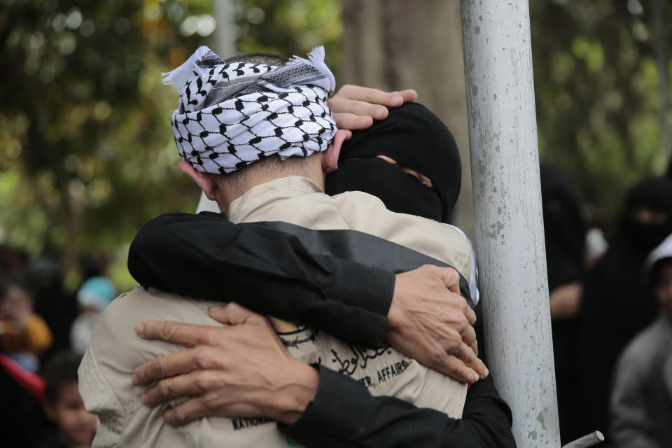 A Houthi prisoner hugs his mother as he arrives to Sanaa airport, Saturday, April 15, 2023. An exchange of more than 800 prisoners linked to Yemen's long-running war them began Friday, the International Committee for the Red Cross said. The three-day operations will see flights transport prisoners between Saudi Arabia and Yemen's capital, Sanaa, long held by the Iranian-backed Houthi rebels. (AP Photo/Hani Mohammed)