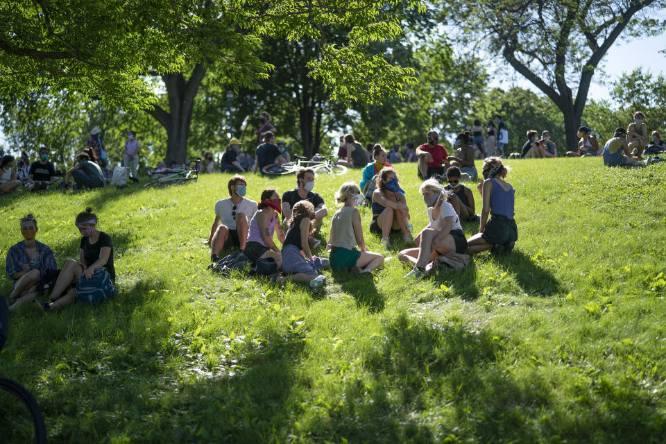 CORRECTS MONTH TO JUNE NOT MAY - Community members gather at "The Path Forward" meeting, a meeting between city council and community members, at Powderhorn Park, Sunday, June 7, 2020, in Minneapolis. The focus of the meeting was to defund the Minneapolis Police Department. ( Jerry Holt/Star Tribune via AP)