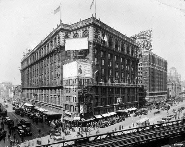 1918:  Exterior view of Macy's department store on 34th Street and Sixth Avenue, New York City. There are trolley cars and pedestrians in the intersection and elevated train tracks in the foreground.  (Photo by Edwin Levick/Hulton Archive/Getty Images)