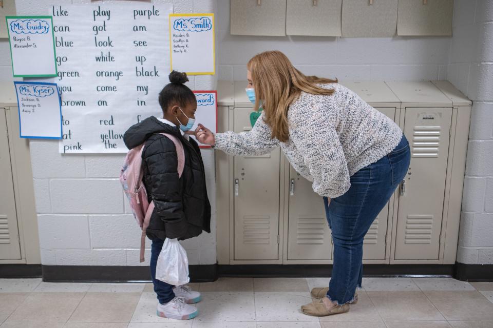 Kindergarten teacher, Rhonda Guidry, right, comforts AuDriel Jones as children arrive Monday morning returning to in-person classes at Carter Elementary. Jan. 24, 2022