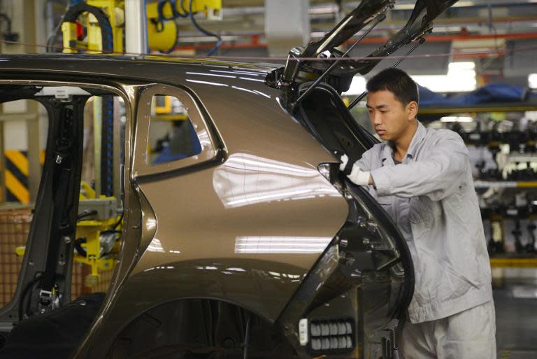 Workers at the Dongfeng Peugeot-Citroen plant in Wuhan in China's central Hubei province on December 7, 2013. The IMF predicts China's economy will grow 7.5% this year