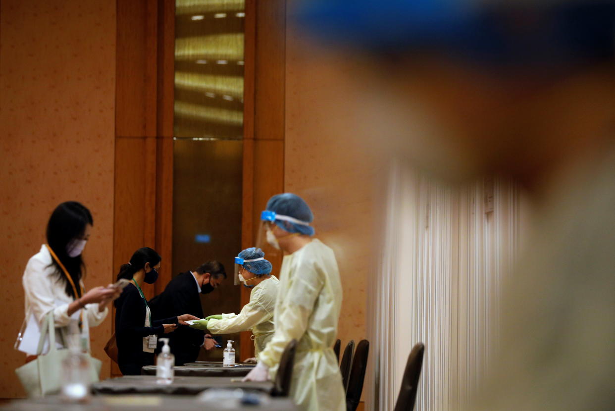 Attendees taking an antigen rapid test before a conference held by the Institute of Policy Studies at Marina Bay Sands Convention Centre in Singapore.