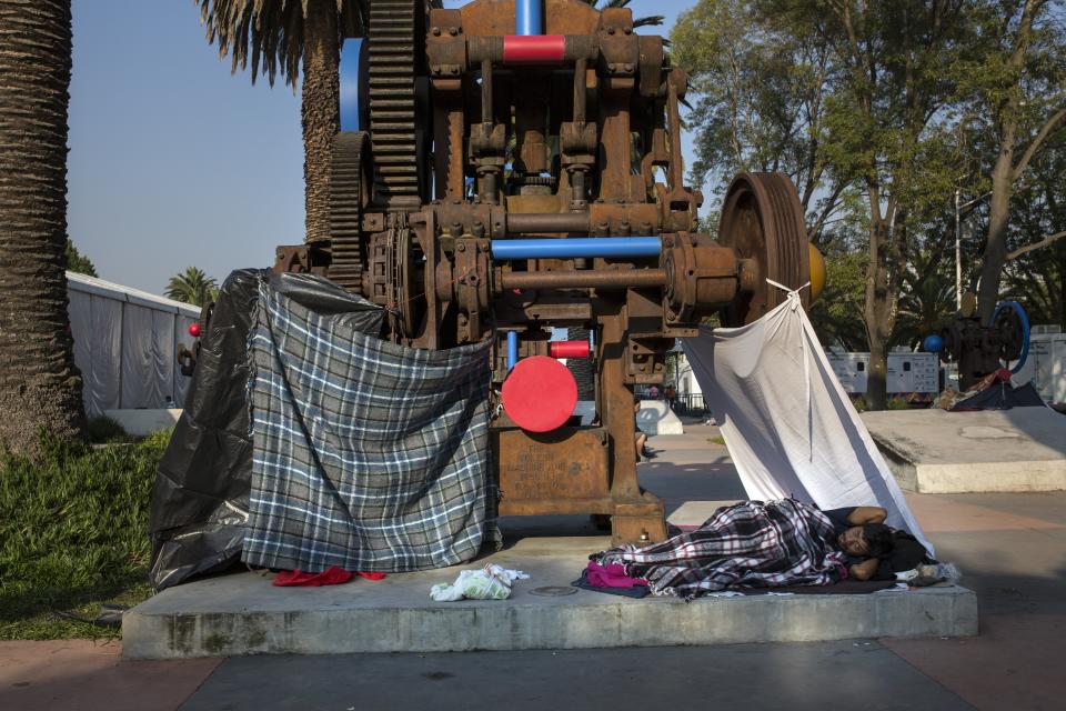 Juan Antonio Ortiz, 38, from Guatemala, rests in a makeshift shelter at the Jesus Martinez stadium in Mexico City, Wednesday, Nov. 7, 2018. Central American migrants on Wednesday continued to straggle in for a rest stop at a Mexico City stadium, where about 4,500 continue to weigh offers to stay in Mexico against the desire of many to reach the U.S. border. (AP Photo/Rodrigo Abd)