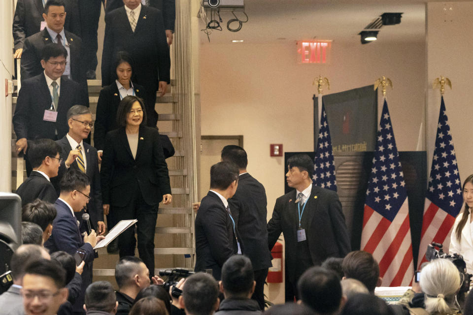 Taiwan's President Tsai Ing-wen, second from left on stairs, arrives at an event at the Taipei Economic and Cultural Office in New York, Thursday, March 30, 2023. (AP Photo/Yuki Iwamura)
