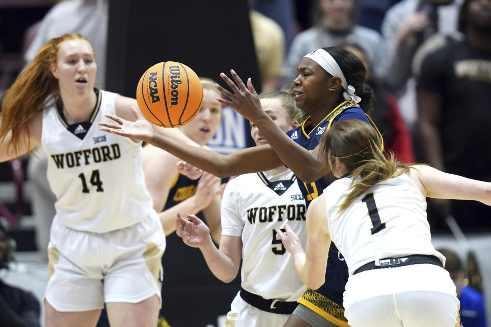 Chattanooga guard Yazz Wazeerud-Din (13) tries to hang on to a loose ball surrounded by Wofford forward Lilly Hatton (14), Wofford guard Helen Matthews (5) and Wofford guard Annabelle Schultz (1) in the first half of an NCAA women's college basketball championship game for the Southern Conference tournament, Sunday, March 5, 2023, in Asheville, N.C. (AP Photo/Kathy Kmonicek)