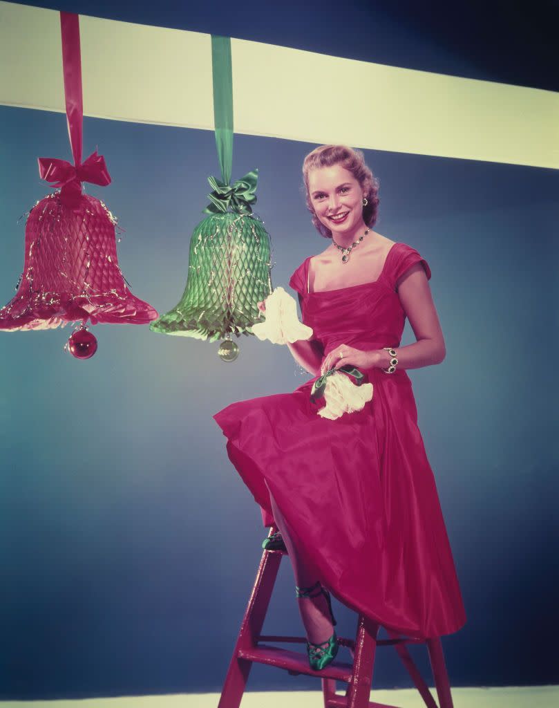 <p>Janet Leigh dons a classic cap-sleeve dress in festive red at a photoshoot in 1955. The actress even went as far as to coordinate green shoes and jewelry for the ultimate Christmas look. </p>