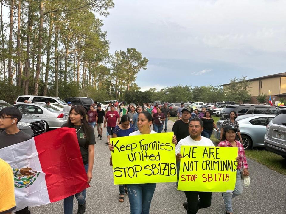 Protesters hold signs and shout against SB 1718 and Gov. Ron DeSantis as they march around the Mission San Jose of Saint Peter Church in Pierson, Thursday, June 1, 2023.