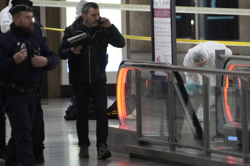 Police investigators work inside the Gare de Lyon station after an attack, Saturday, Feb. 3, 2024 in Paris. A man seemingly armed with a knife and a hammer injured three people Saturday in an early-morning attack at the major Gare de Lyon train station in Paris, another nerve-rattling security incident in the Olympic host city before the Summer Games open in six months. (AP Photo/Christophe Ena)