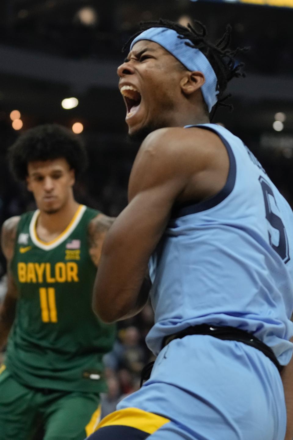 Marquette's Chase Ross reacts after his dunk during the first half of an NCAA basketball game Tuesday, Nov. 29, 2022, in Milwaukee. (AP Photo/Morry Gash)