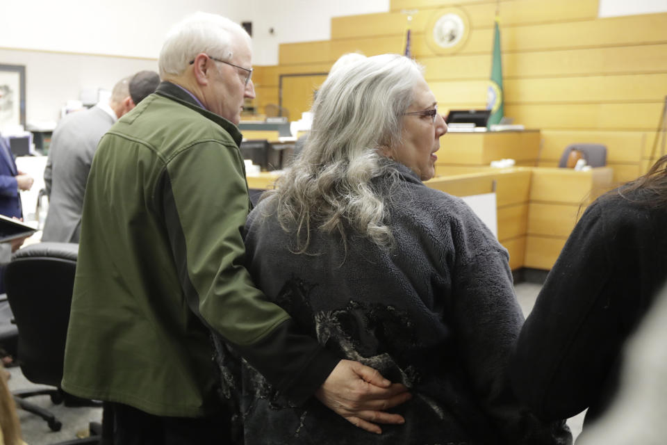 Chuck Cox, left, and his wife, Judy Cox, right, stand Tuesday, Feb. 18, 2020, during a break in a session of Pierce County Superior Court in Tacoma, Wash., on the first day of a civil lawsuit over the murder of the Cox's young grandsons. Chuck and Judy are the parents of missing Utah woman Susan Cox Powell and the grandparents of Susan's sons Charlie and Braden, who were attacked and killed by their father Josh Powell in 2012 while he was under suspicion for Susan Powell's disappearance. The Coxes allege that negligence by the Washington state Department of Social and Health Services was a contributing factor that led to the deaths of their grandsons. (AP Photo/Ted S. Warren)