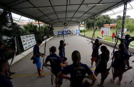 Competitors attend an archery match at Brazilian Archery Confederation in Marica, near Rio de Janeiro March 21, 2015. REUTERS/Ricardo Moraes