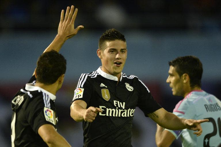 Real Madrid's James Rodriguez (C) celebrates after scoring a goal during their Spanish La Liga match against Celta Vigo, at the Balaidos stadium in Vigo, on April 26, 2015