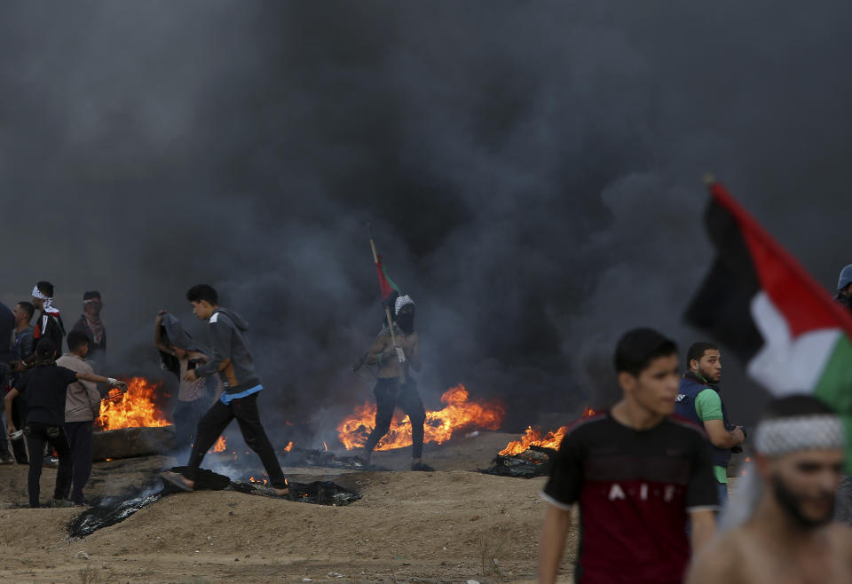 Protesters burn tires near the fence of the Gaza Strip border with Israel during a protest east of Gaza City, Friday, Oct. 26, 2018. (AP Photo/Adel Hana)