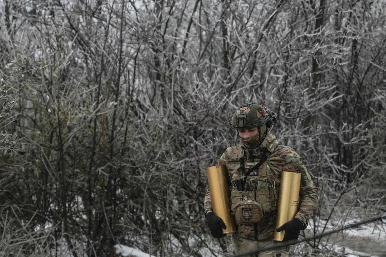 Ukrainian serviceman carries shells for a self-propelled howitzer at a position in a front line near the town of Bakhmut (REUTERS)