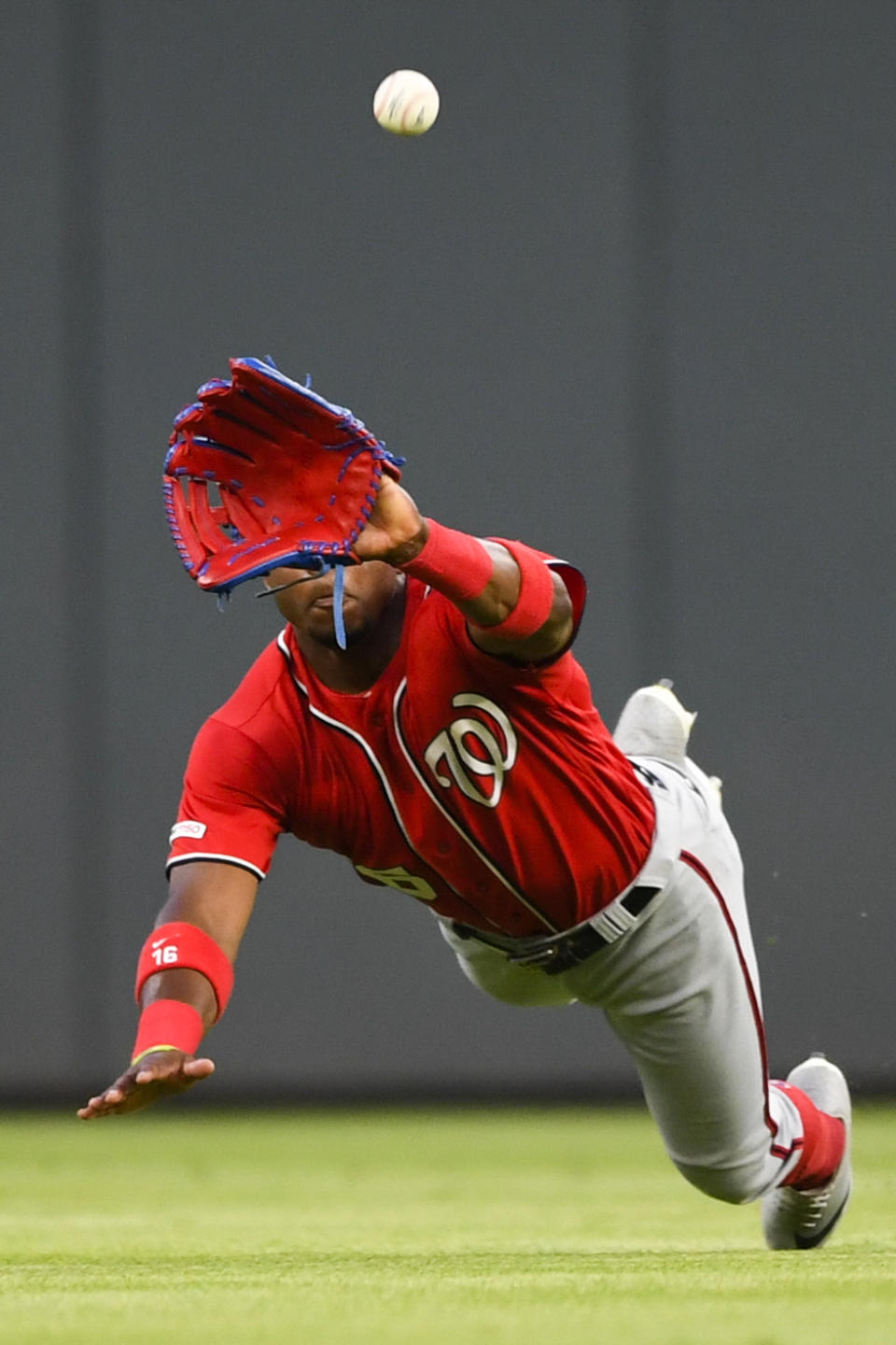 Washington Nationals center fielder Victor Robles makes a diving catch on a ball off the bat of Atlanta Braves' Dansby Swanson during the fifth inning of a baseball game Sunday, July 21, 2019, in Atlanta. (AP Photo/John Amis)