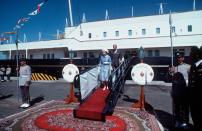 <p>Queen Elizabeth II and Prince Philip come ashore from the royal yacht Britannia to say farewell to the Amir of Kuwait and his ministers in Kuwait in 1979.</p>