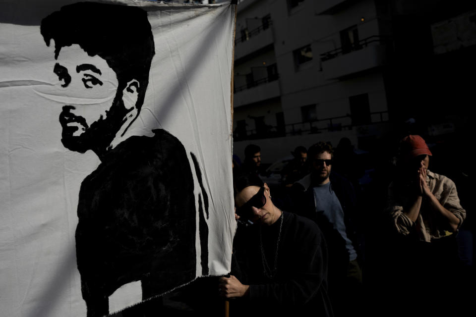 Families and supporters of Israeli hostages held by Hamas in Gaza hold photos of their loved ones at a protest calling for their return, outside a meeting between U.S. Secretary of State Antony Blinken and Israeli President Isaac Herzog, in Tel Aviv, Israel, Tuesday, Jan. 9, 2024. More than 100 Israeli hostages are held in Gaza after being abducted in a Hamas cross-border attack on Oct. 7.(AP Photo/Oded Balilty)