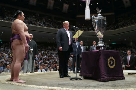 U.S. President Donald Trump prepares to present the President’s Cup to wrestler Asanoyama, the winner of the Summer Grand Sumo Tournament at Ryogoku Kokigikan Sumo Hall in Tokyo, Japan May 26, 2019. REUTERS/Jonathan Ernst