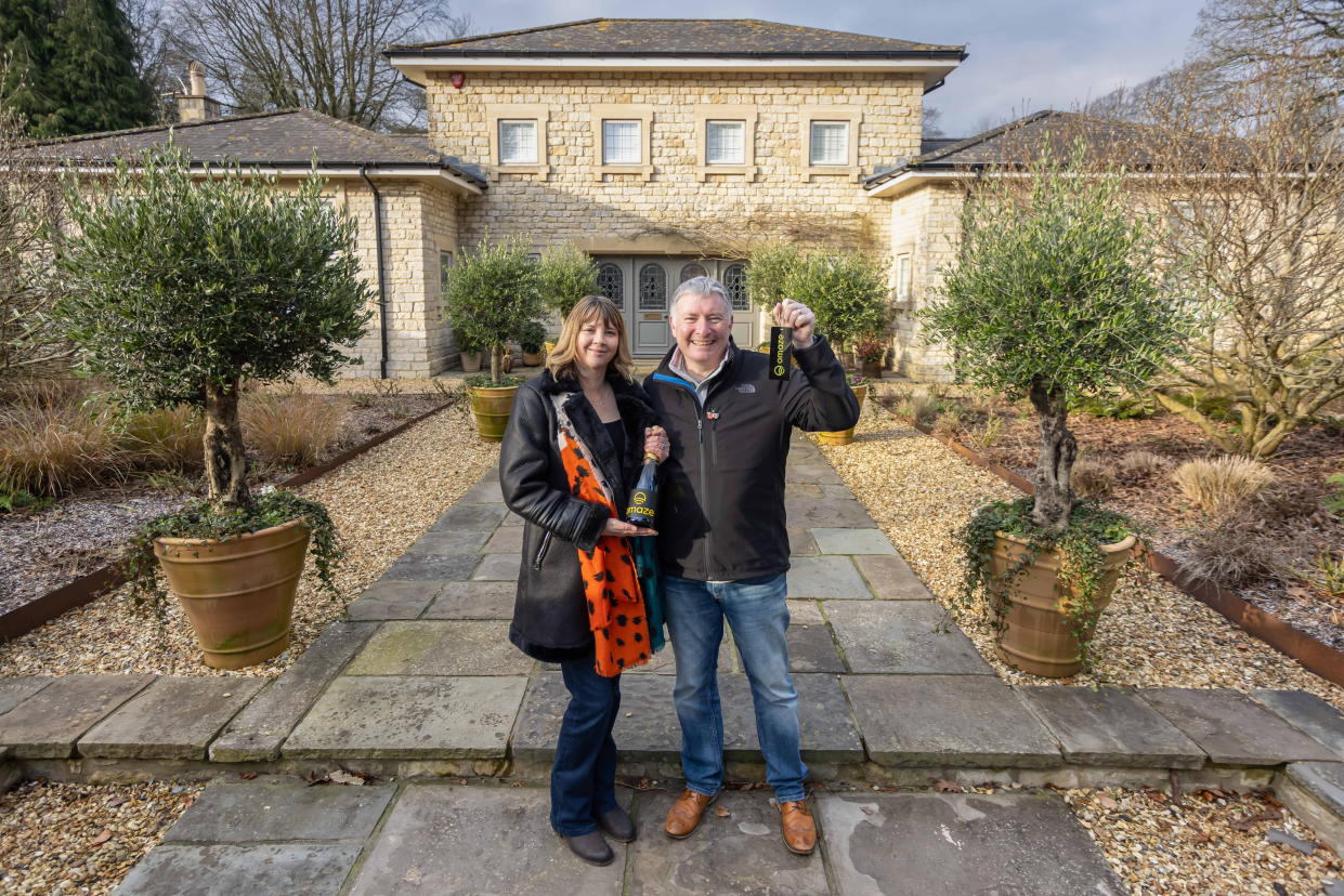 Michael Maher and wife Amanda outside the £3 million house in Somerset that they won in the Omaze draw. (SWNS)