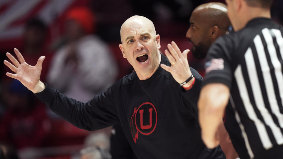 Utah head coach Craig Smith, left, argues with a referee during the second half of an NCAA college basketball game against Stanford, Thursday, Feb. 2, 2023, in Salt Lake City. (AP Photo/Rick Bowmer)