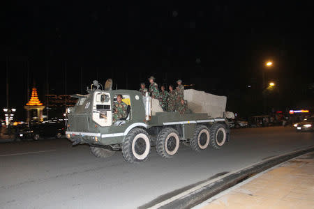 Cambodian soldiers sit on an army vehicle as they move to Cambodia-Laos borders, in Phnom Penh, Cambodia August 11, 2017. REUTERS/Stringer NO SALES NO ARCHIVES