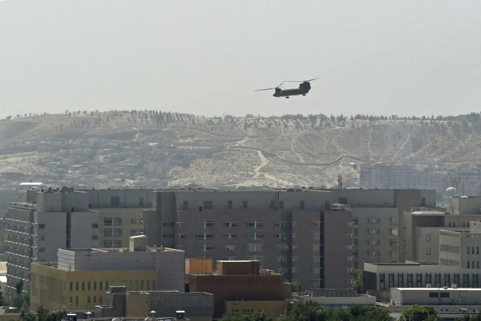 A U.S. military helicopter is pictured flying above the U.S. embassy in Kabul on August 15, 2021.<span class="copyright">WAKIL KOHSAR/AFP via Getty Images</span>