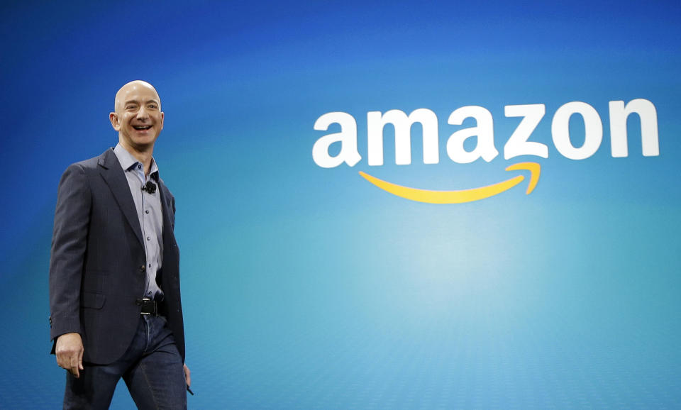 FILE - In this June 16, 2014, file photo, Amazon CEO Jeff Bezos walks onstage for the launch of the new Amazon Fire Phone, in Seattle. Amazon has had a complicated few weeks with its cancellation of a New York headquarters Thursday, Feb. 14, 2019, and extortion claims last week related to intimate photos taken by its founder. Experts say the events are unlikely to pose much of a threat to Amazon’s business. But the company will continue to face more challenges as it grows larger. (AP Photo/Ted S. Warren, File)