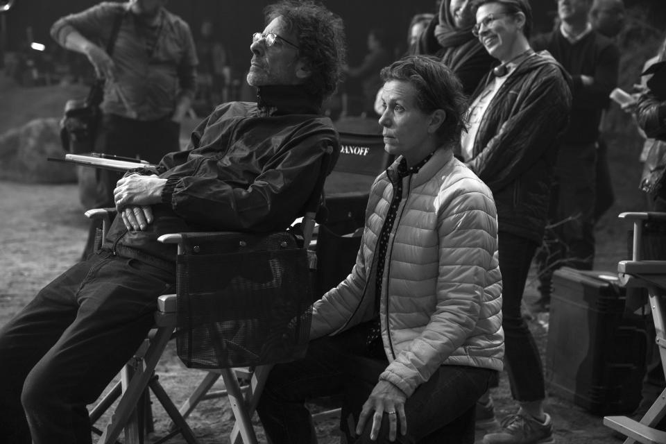 This image released by A24 shows director Joel Coen, left, and actor Frances McDormand on the set of "The Tragedy of Macbeth." (A24 via AP)