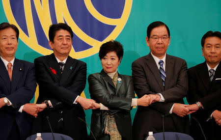 Leaders of Japan's main political parties (L-R) Komeito Party leader Natsuo Yamaguchi, Japan's Prime Minister Shinzo Abe, head of Japan's Party of Hope and Tokyo Governor Yuriko Koike, Communist Party Chairman Kazuo Shii and Constitutional Democratic Party leader Yukio Edano pose for a photograph at the start of debate session ahead of October 22 lower house election, at the Japan National Press Club in Tokyo, Japan October 8, 2017. REUTERS/Kim Kyung-Hoon